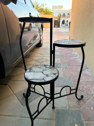 Three-tier metal plant stand with stone-top shelves. Bought from pan home. Used only once.
