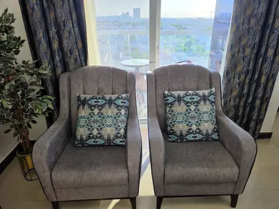 Pair of comfortable grey upholstered armchairs — excellent condition (Free Blue Carpet)