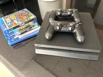PS4 Slim with 2 Controllers and 4 Games - Good Condition + games