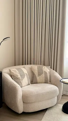 Cozy boucle swivel armchair in beige — excellent condition