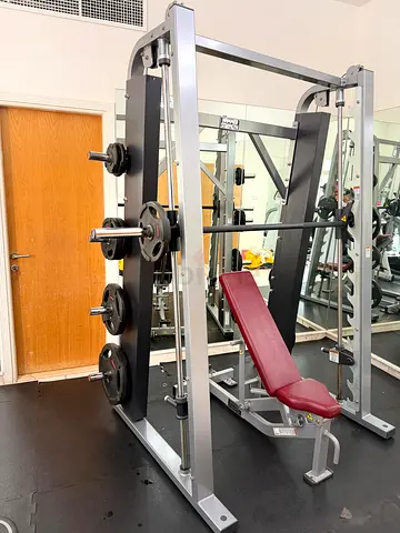Hammer strength smith machine with weights and bench