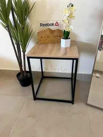 Compact wood-top side table with black metal frame