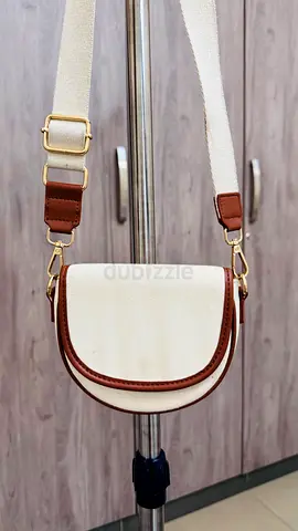 Cream crossbody saddle bag with adjustable strap