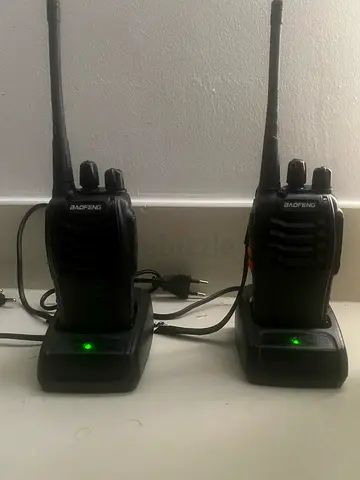 Pair of handheld Baofeng-style two-way radios with chargers