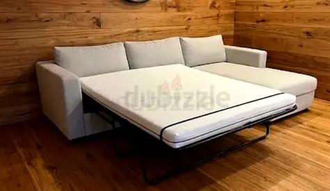 Light grey L-shaped sofa with pull-out bed (chaise right)