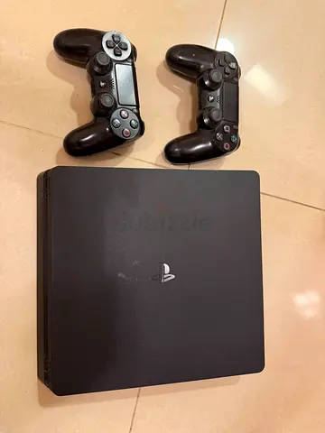PlayStation 4 Slim with 2 DualShock 4 Controllers - Good Working Condition