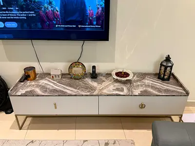 Modern TV stand with marble top and gold accents