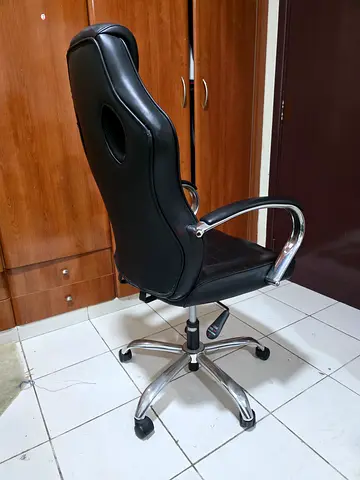 Black leather office swivel chair with chrome base — good condition