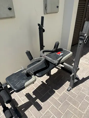 Used multi-function weight bench with leg curl/extension attachments