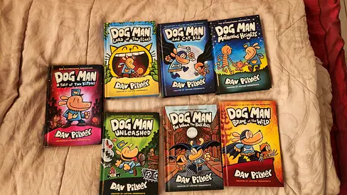 Set of 7 Dog Man graphic novels by Dav Pilkey - ALL hardback covers. Good used condition.