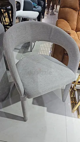 Light grey upholstered dining/occasional chair with curved back