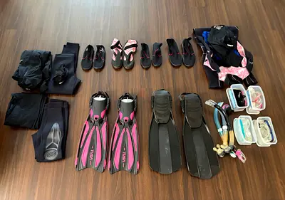 Full set of snorkeling/diving gear — fins, masks, snorkels, wetsuits and accessories