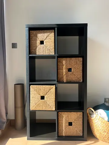 Black IKEA Kallax shelving unit for sale. Includes 4 storage boxes.