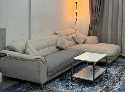 Light grey L-shaped fabric sofa with chaise — good condition