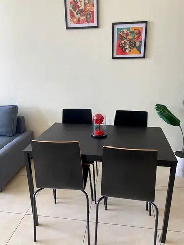 IKEA-style black dining table with 4 chairs - good condition