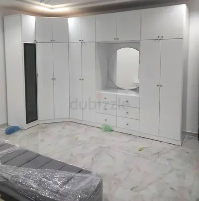 white built-in wardrobe with vanity and mirror — complete bedroom storage