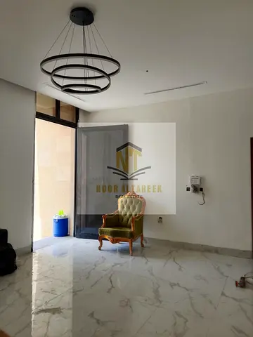 Luxury villa for sale in Al Hooshi, Sharjah, featuring 5 master bedrooms, a majlis, a living room, a maid's room, and a balcony. Prime location close
