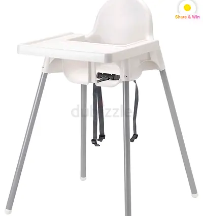 Simple white baby high chair with tray and safety straps