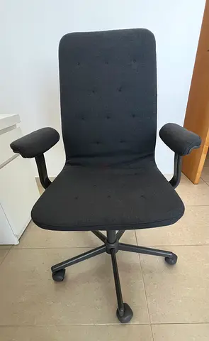 Comfortable black swivel office chair with armrests