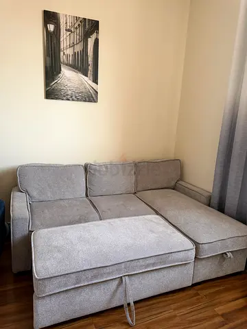 Light grey L-shaped fabric sofa with ottoman - good condition
