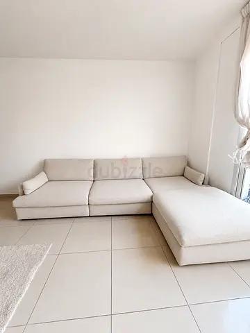 Light grey L-shaped fabric sofa with chaise lounge