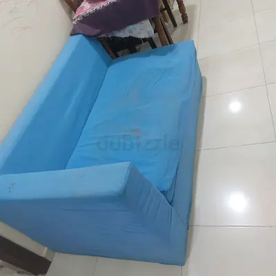Two-seater blue sofa in fair used condition