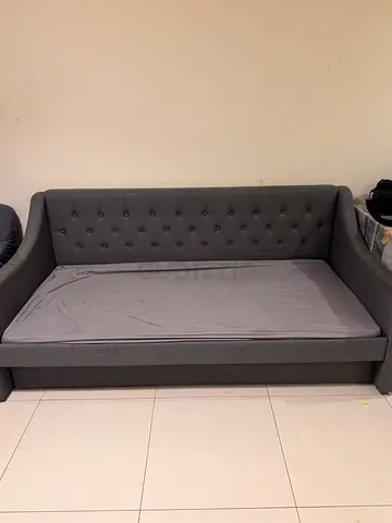 Grey fabric sofa with trundle bed - good condition