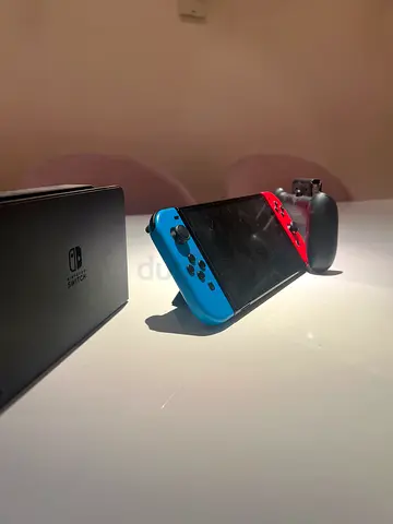 Nintendo Switch oled Console with Neon Blue and Red Joy-Cons and Charging Grip negotialble