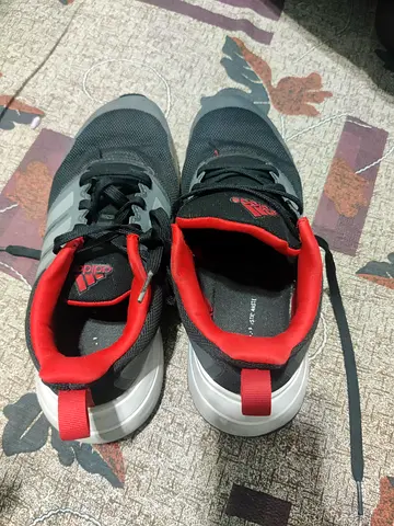 Black and red Adidas running shoes - used