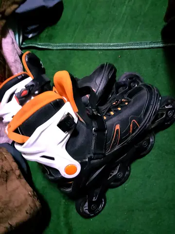Used black and orange inline roller skates, size small/medium