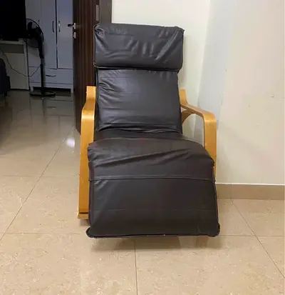 Comfortable brown leather reclining lounge chair with wooden frame