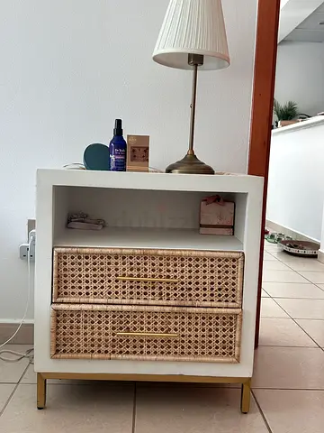 Small white bedside table with cane drawer fronts and brass legs