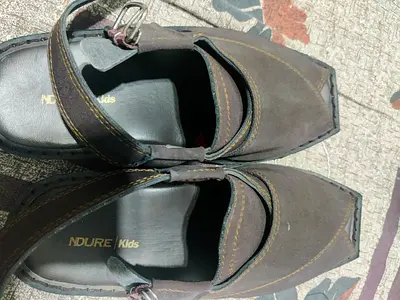 Pair of brown NDURE Kids leather shoes, size unknown, gently used