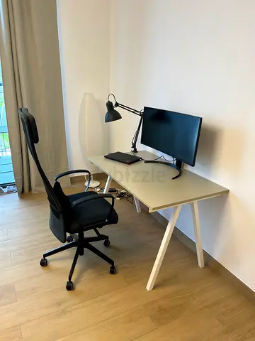 Minimalist IKEA white study desk with ergonomic office chair and lamp