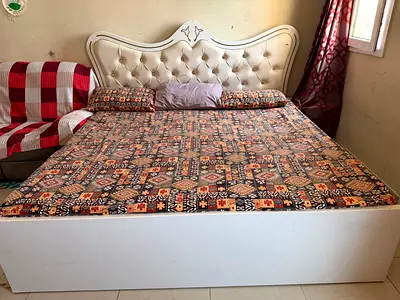 White tufted king size double bed with storage base and mattress