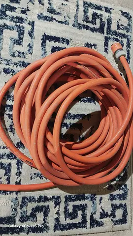 Used flexible orange water hose - 20m (approx)