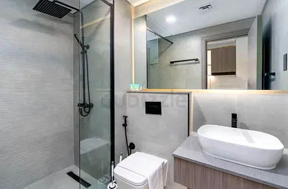Modern grey tiled bathroom with walk-in shower and vanity