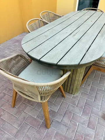 Outdoor oval wooden dining table with 6 wicker chairs - used