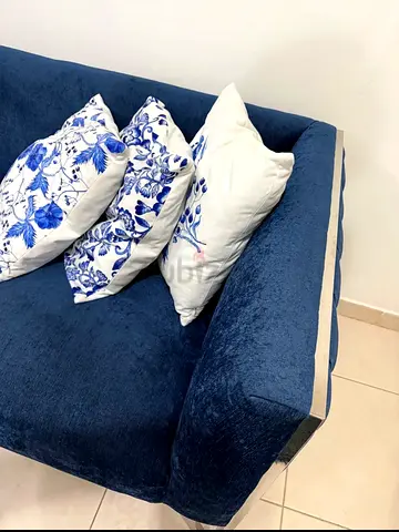 Blue velvet 3- 2 seater sofas with chrome legs and cushions and Rugs