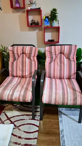 Pair of outdoor/indoor metal frame chairs with striped cushions