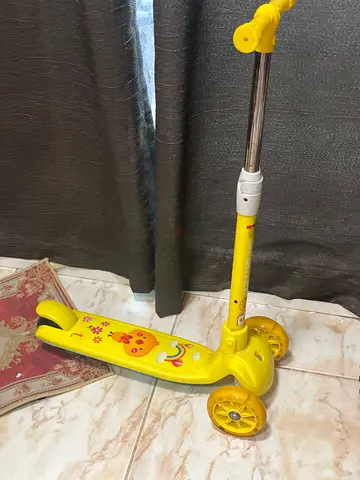 Yellow three-wheel kids scooter with adjustable handle