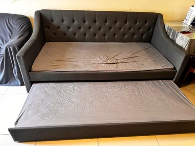 Grey fabric sofa with trundle bed - good condition