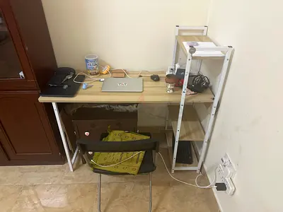 Compact study table with attached shelving - light wood