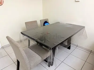 Black dining table with 5 upholstered chairs - good condition