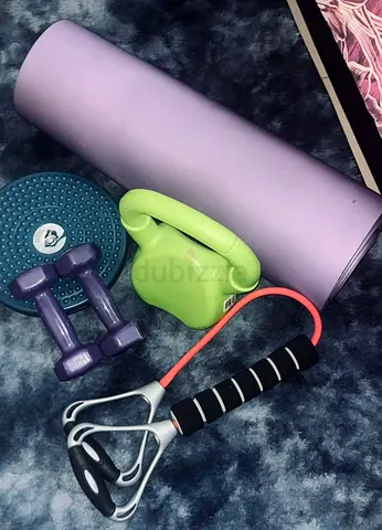 Home workout set: yoga mat, dumbbells, resistance handles  core trainer