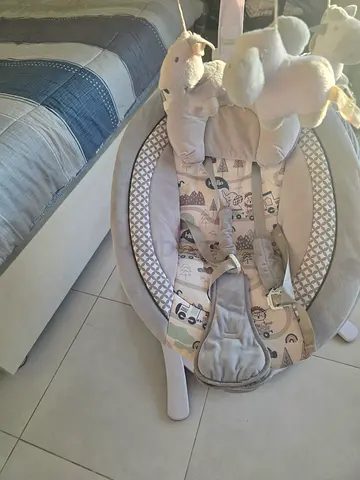 Gently used baby bouncer/rocker with toy bar, Music and remote control