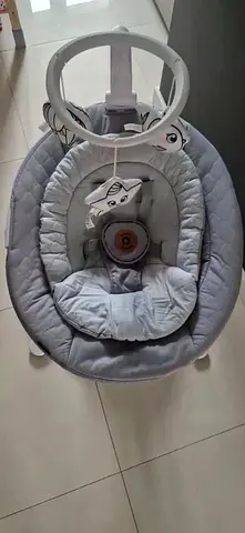 Light grey baby bouncer/rocker with toy bar - gently used