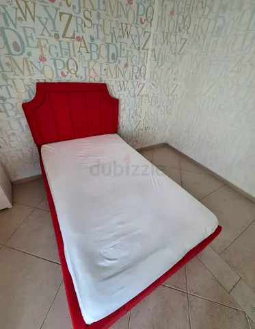 Spacious Single Bed with Mattress and Soft Red Upholstered Headboard
