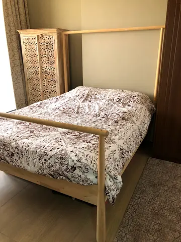 Wooden double bed frame with carved headboard - good condition