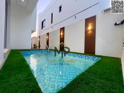 Luxury villa with swimming pool for sale in Ajman Al Zahia, including fees, electricity, and water.